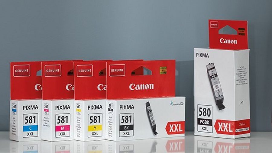Arrangement of Canon ink and toner cartridges with their packaging.