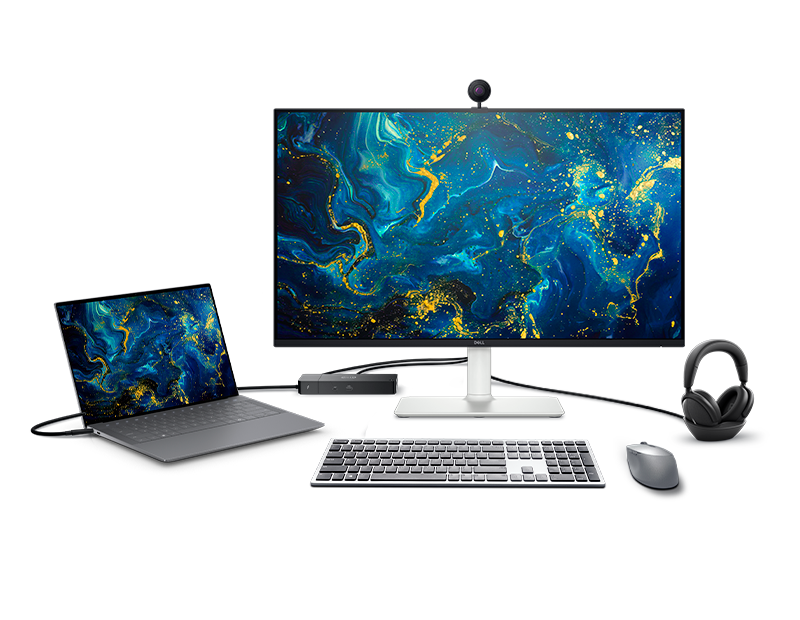 Flat-lay or desk shot of Dell accessories — a docking station, keyboard, mouse and webcam arranged together.