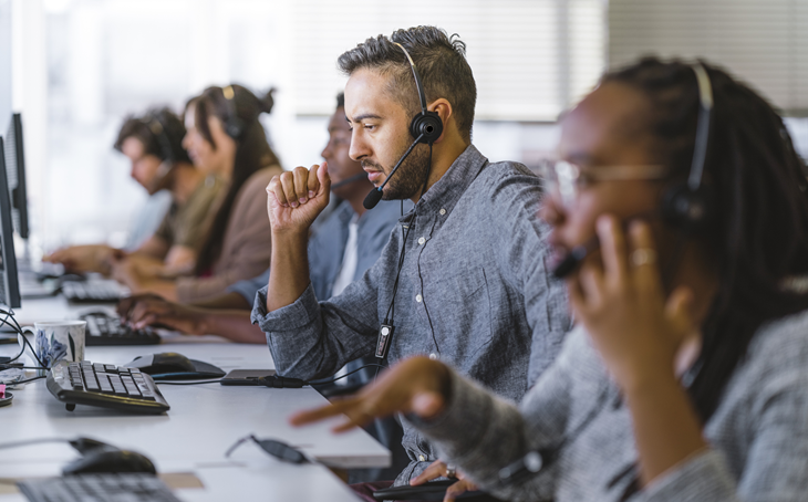 Team of IT professionals collaborating in a network operations centre setting.