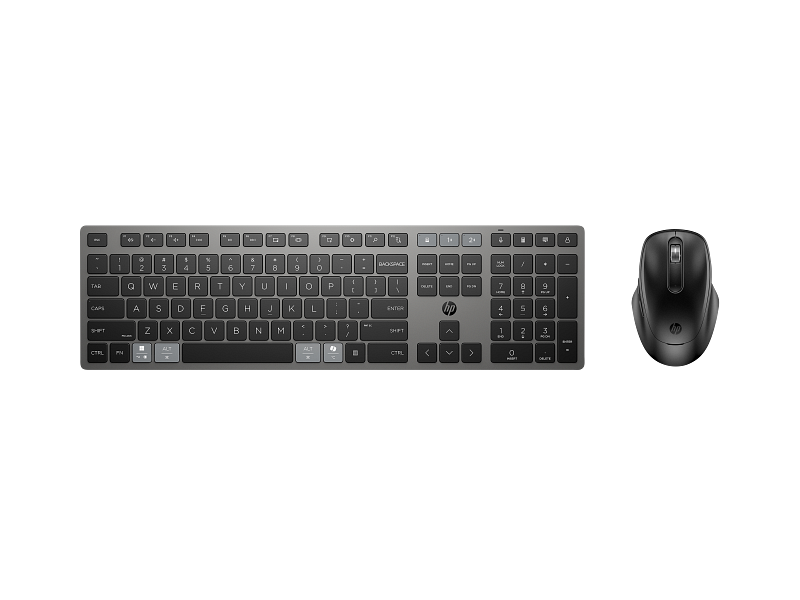 Flat-lay product shot of assorted HP accessories — toner cartridge, mouse, keyboard, and cables — arranged neatly on a plain background.