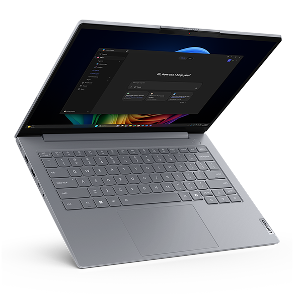 Product shot of a Lenovo ThinkBook laptop open on a modern desk in a bright, contemporary office setting.