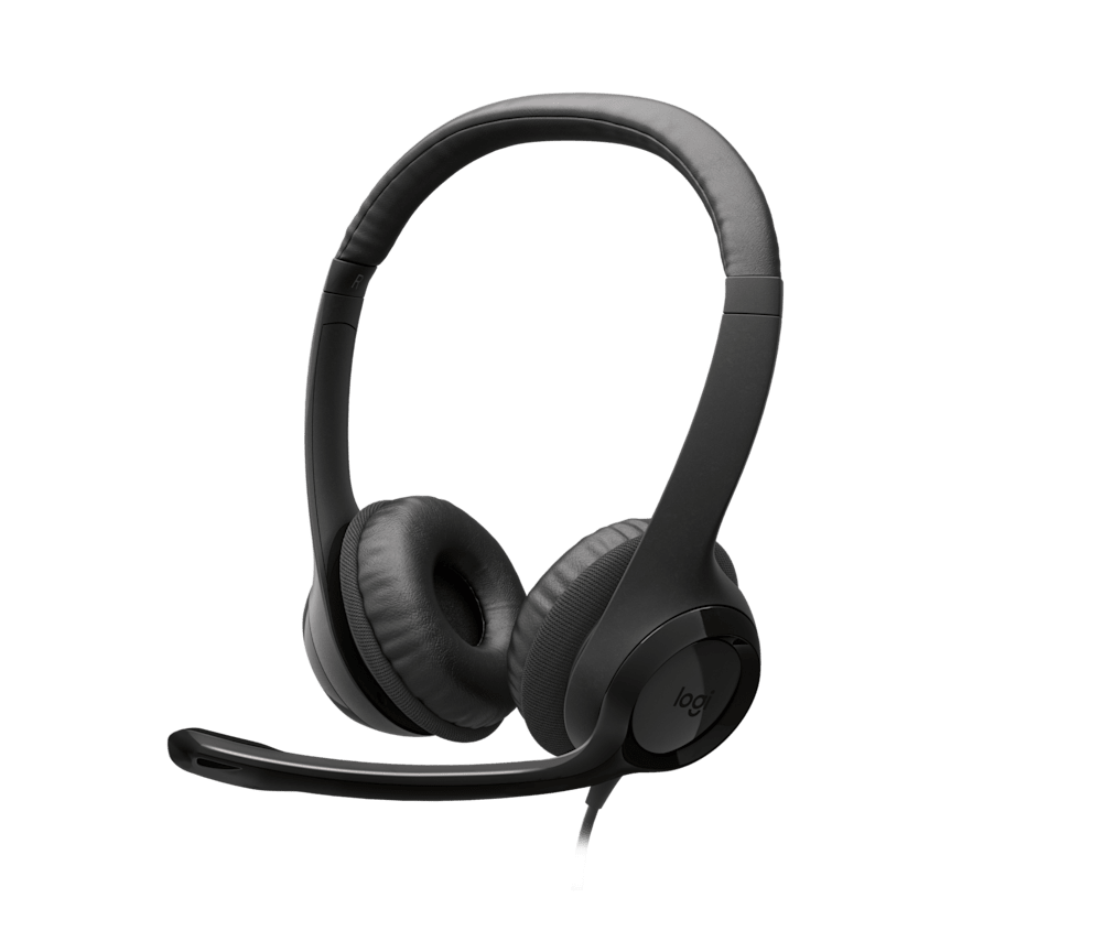 Logitech USB headset on a desk beside a laptop.